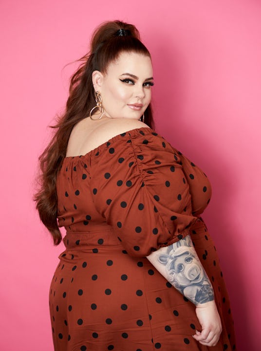 Model and activist, Tess Holiday wearing a red dress with black polka dots 