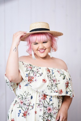 Designer and winner of Project Runway, Ashley Nell Tipton wearing a white dress with flowers
