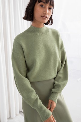 A model in an & Other Stories pistachio mock neck sweater 