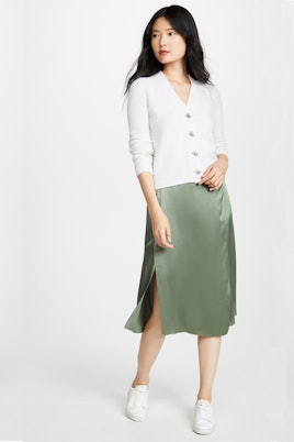 A model in a Vince pistachio drape panel skirt