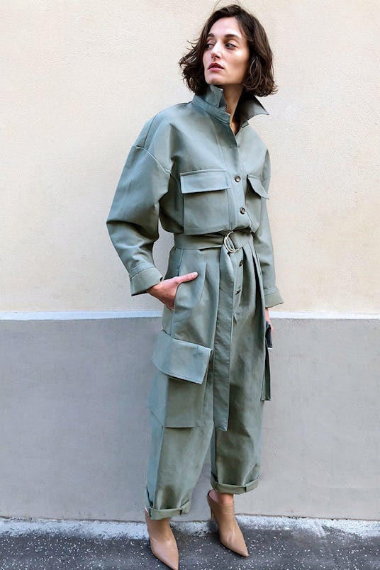 A model in Frankie Shop's Linda cargo jumpsuit in sage green