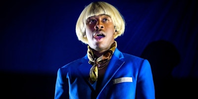 Singer Tyler Gregory Okonma better known as Tyler, the Creator wearing a light blue suit and a blond...