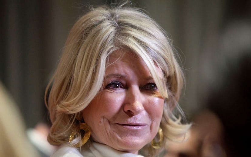 A closeup of Martha Stewart with light curls and golden earrings