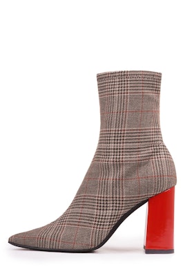 Ankle boot with a plaid pattern and a red heel 
