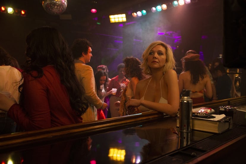 Maggie Gyllenhaal sitting at a bar with blonde hair in The Deuce
