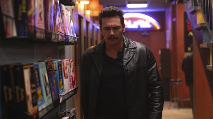 Vincent played by James Franco in a scene from The Deuce next to magazines