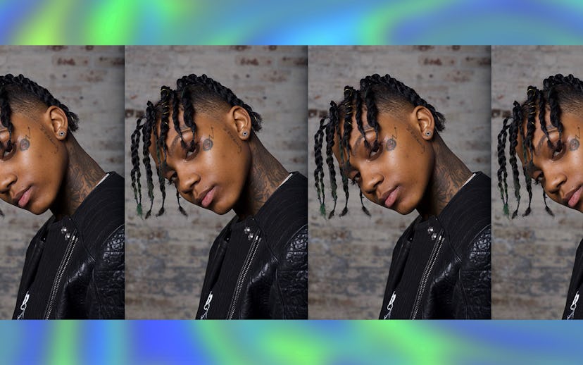 Young rapper Nimic Revenue wearing a black leather jacket and looking at a camera