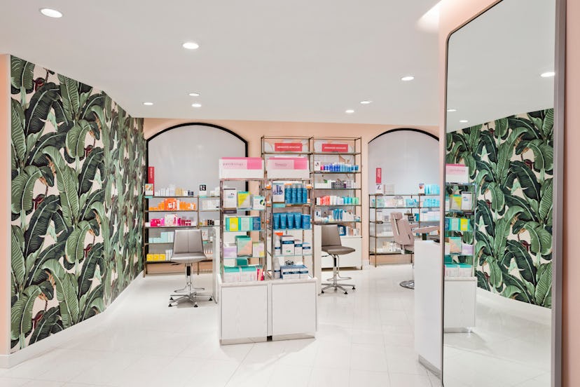 Nordstrom's New York City peach-colored room with mirrors and plants on walls filled with beauty pro...