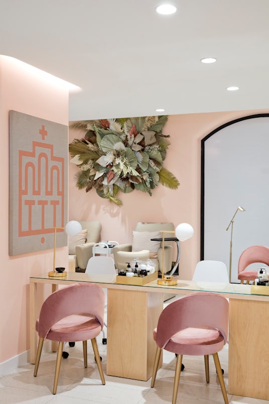 Nordstrom's New York City peach-colored room with a table, pink chairs and beauty products