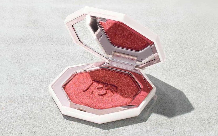 Fenty Beauty highlighter open and being lit by a harsh light