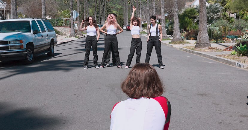 Nasty Cherry members posing in white tank tops and black pants 