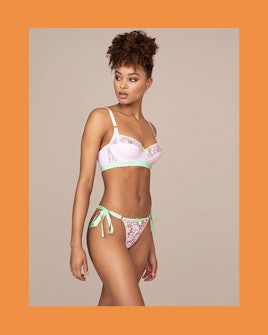 The model wearing Agent Provocateur's pastel green and pink Quin balconette underwired bra and tie-s...
