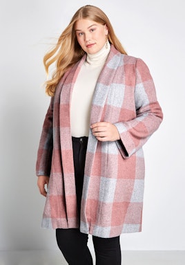 A blonde model wearing Modcloth, Exec in the City Plaid Coat that is in pink and white colors