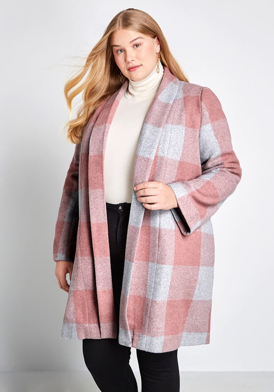 A blonde model wearing Modcloth, Exec in the City Plaid Coat that is in pink and white colors