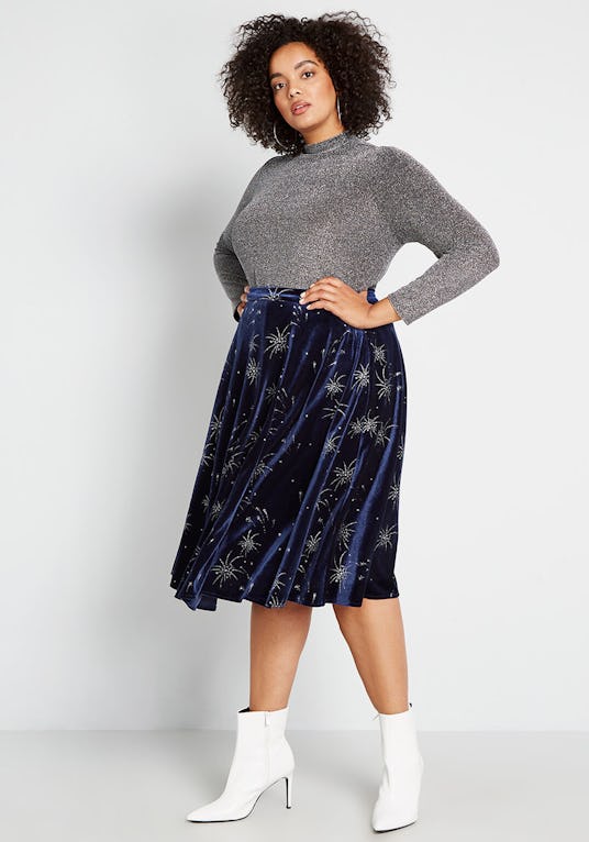 A model in Modcloth, ModCloth x Collectif Let Sparks Fly Midi Skirt paird with a gray turtleneck and...