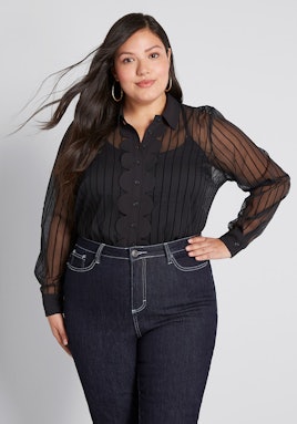 A brunette model wearing Modcloth, black Sheer Confidence Button-Up Top paired with jeans
