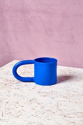 The Workaday Handmade Short Mug in blue with a long handle 