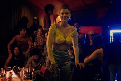 Julia (Julia Fox) in "Uncut Gems" in the club scene, wearing a yellow top