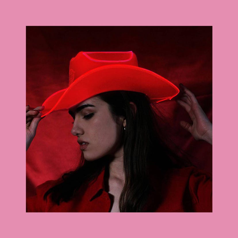 A brunette woman wearing a hat in red by Neon Cowboys