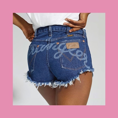 A woman in blue denim jeans shorts with embroidery 