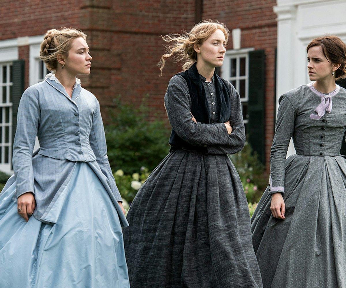 A scene from Greta Gerwigs Little Women, where the three sisters are walking in front of their house