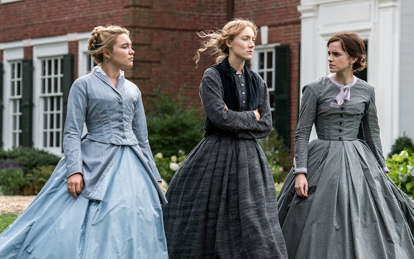 A scene from Greta Gerwigs Little Women, where the three sisters are walking in front of their house