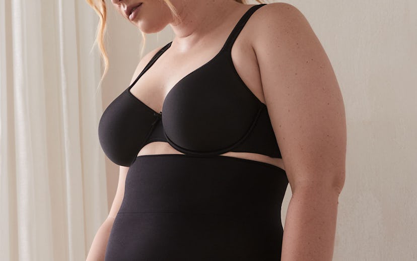 Young lady wearing a black shapewear bra