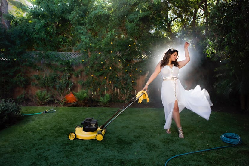 Denise Bidot dancing in a white shapewear dress in her garden