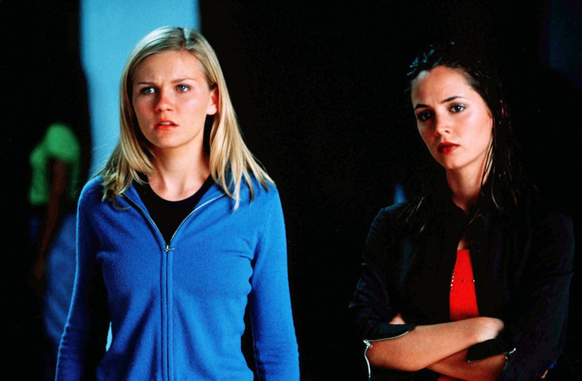 Kirsten Dunst in a light blue zip-up hoodie and Eliza Dushku in a black leather jacket in the "Bring...