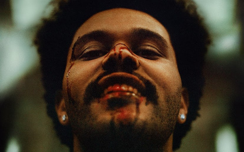 The Weeknd with blood all over his mouth and nose wearing diamond earrings 