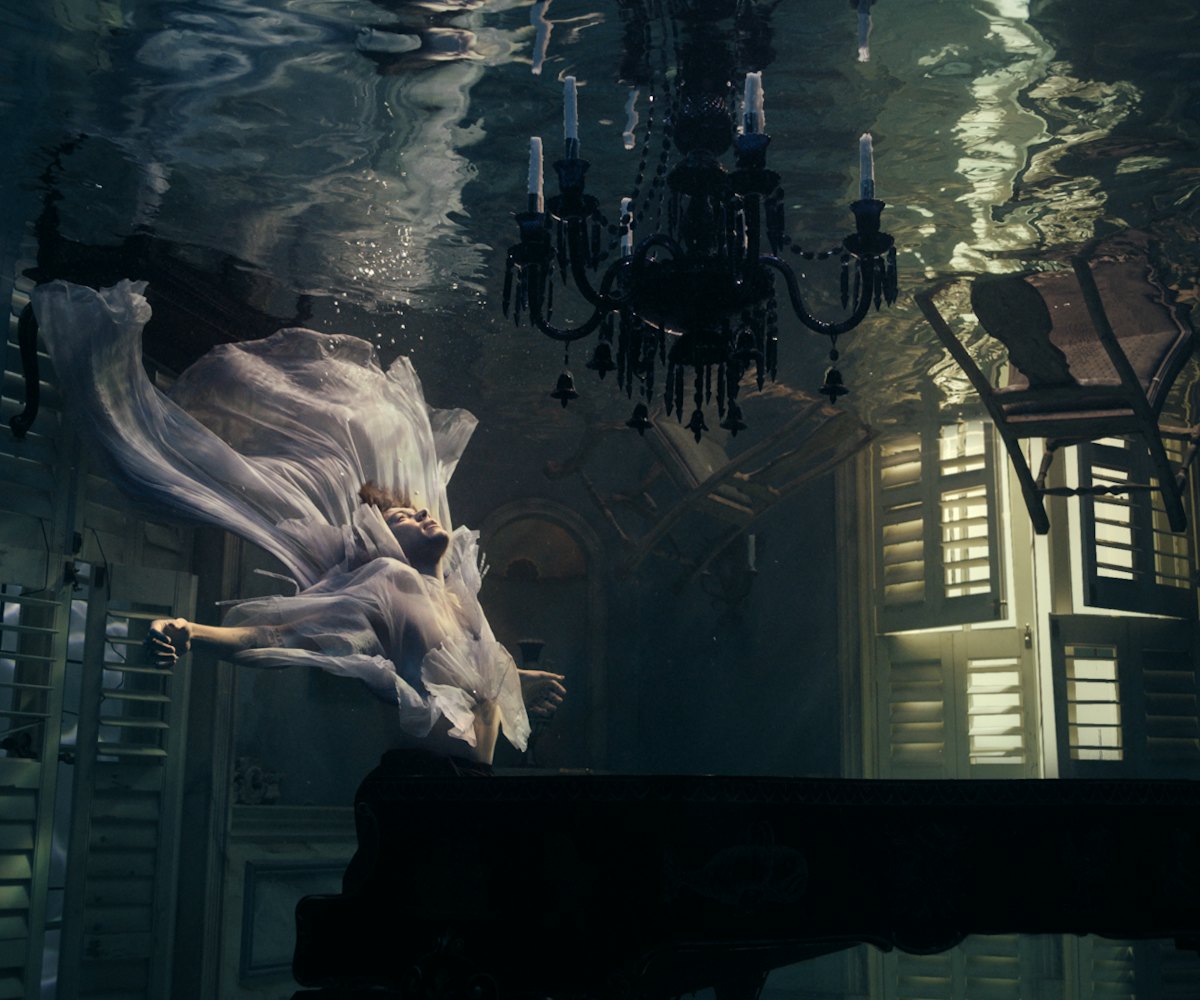 Harry Styles in a room under water during the "Falling" video