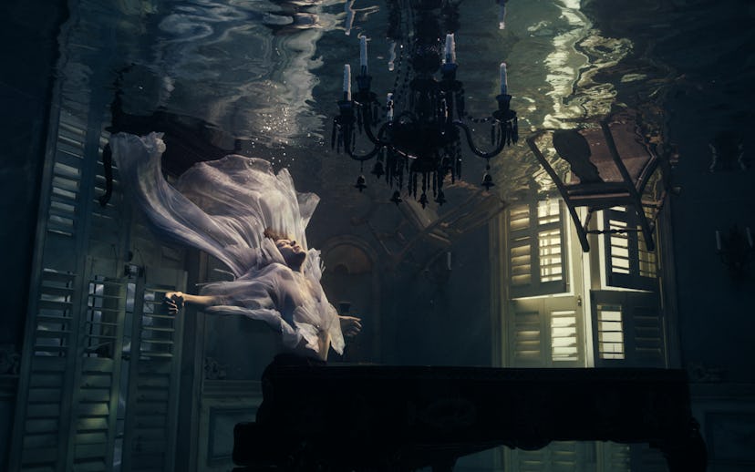 Harry Styles in a room under water during the "Falling" video