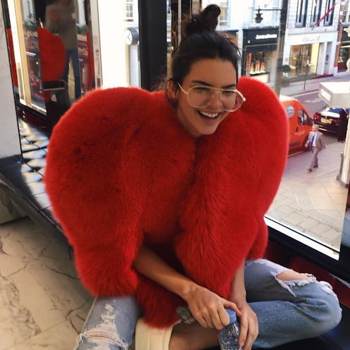 Kendall Jenner wearing an oversized red Saint Laurent fur coat