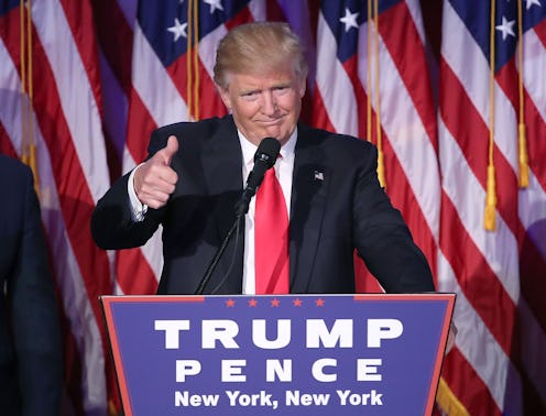 Donald Trump behind the podium, holding thumb up