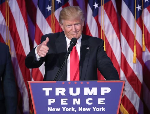 Donald Trump behind the podium, holding thumb up 