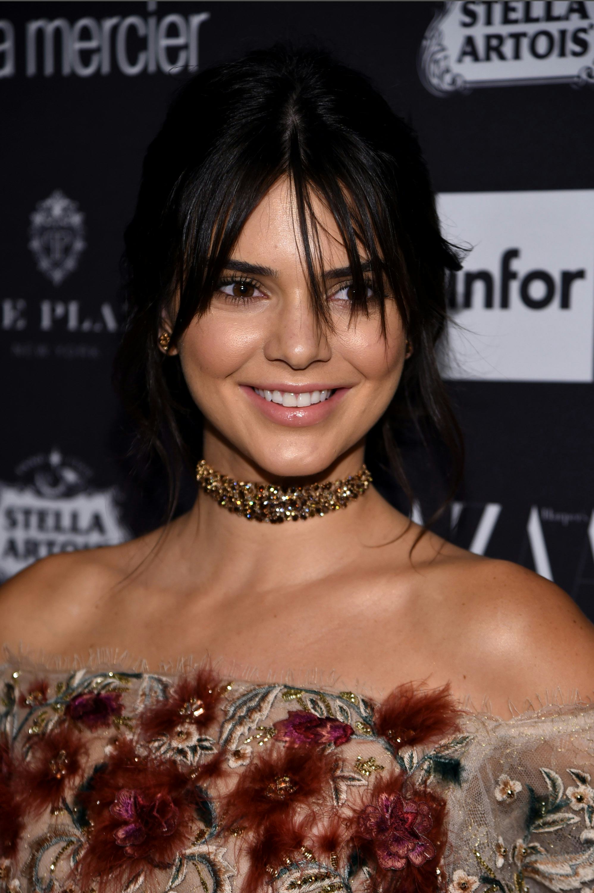 Kendall Jenner in a brown dress with red leather