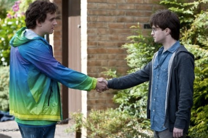 Harry Melling (Dudley) and Daniel Radcliffe (Harry) shake hands in Harry Potter.