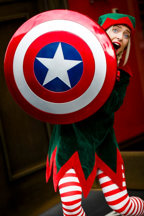 A christmas elf holding captain americas shield
