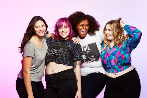 Four women smiling while posing for a photo