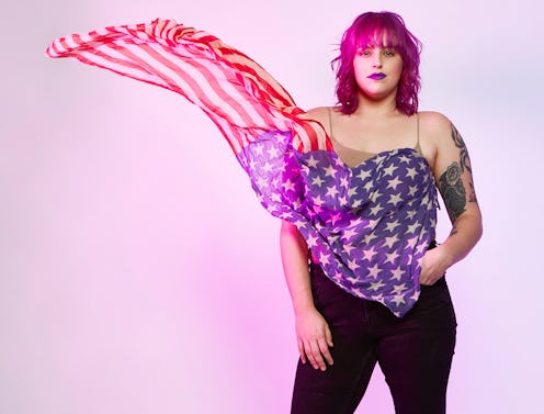 A lady with pink hair wearing an American flag inspired top