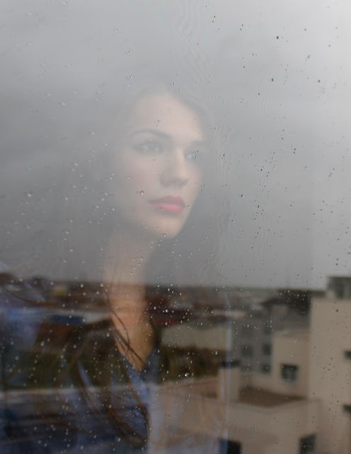 A woman with ADHD looking through a window