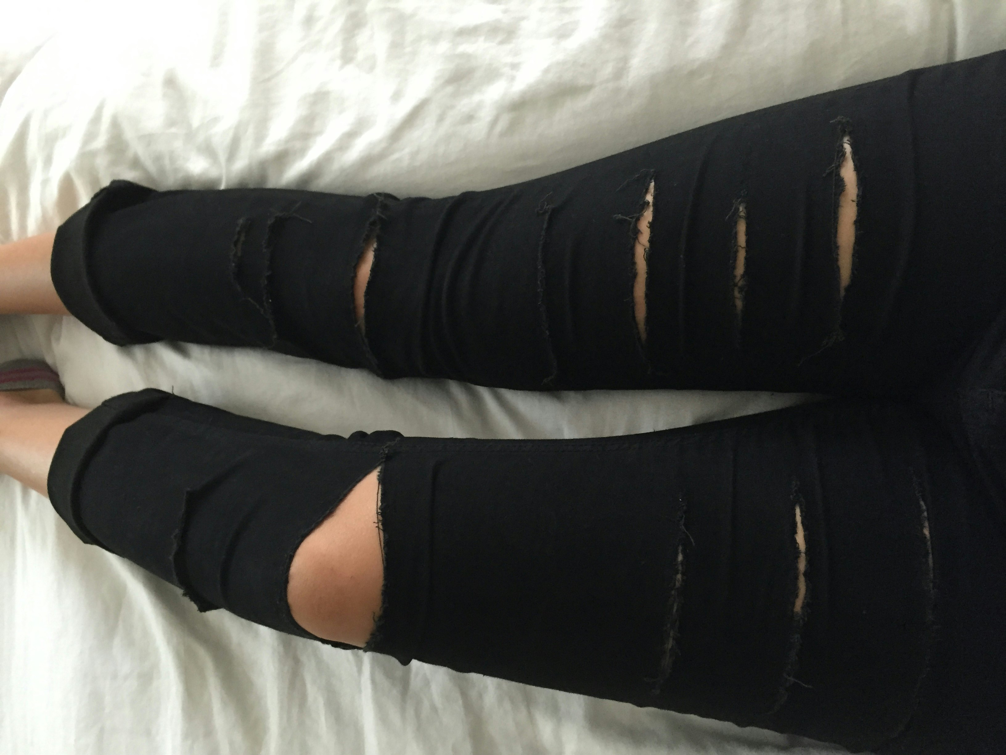 tattered black jeans