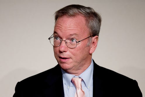Google executive Eric Schmidt wearing a black suit with blue shirt and glasses