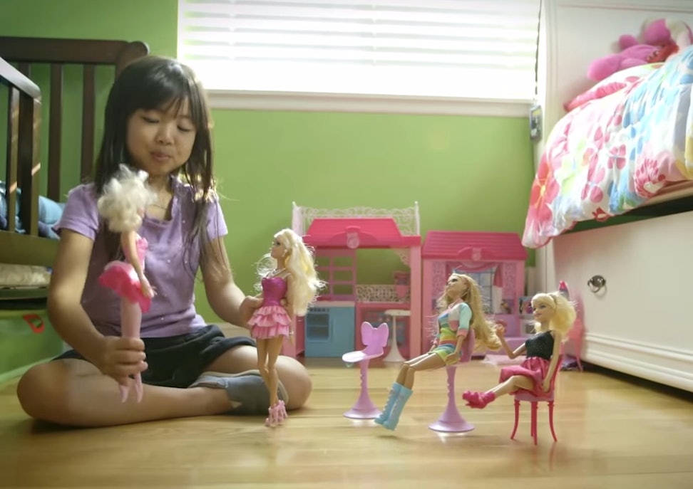 little girls playing with barbies