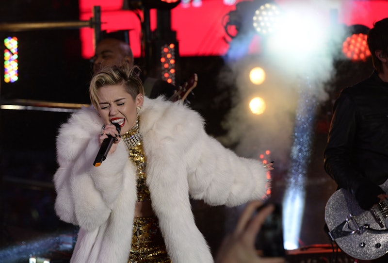 Miley Cyrus wearing a white fur coat during her performance at SXSW