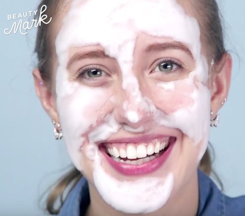 A young lady with fresh white beauty cream smeared over her face