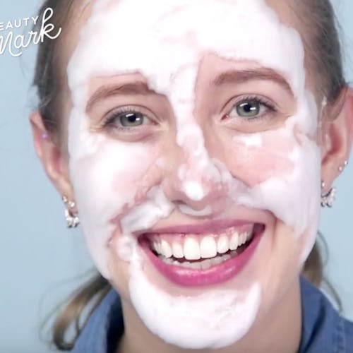 A young lady with fresh white beauty cream smeared over her face