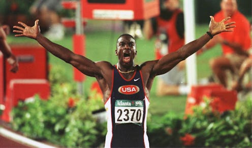The athlete Michael Johnson celebrating finishing the race with his arms in the air