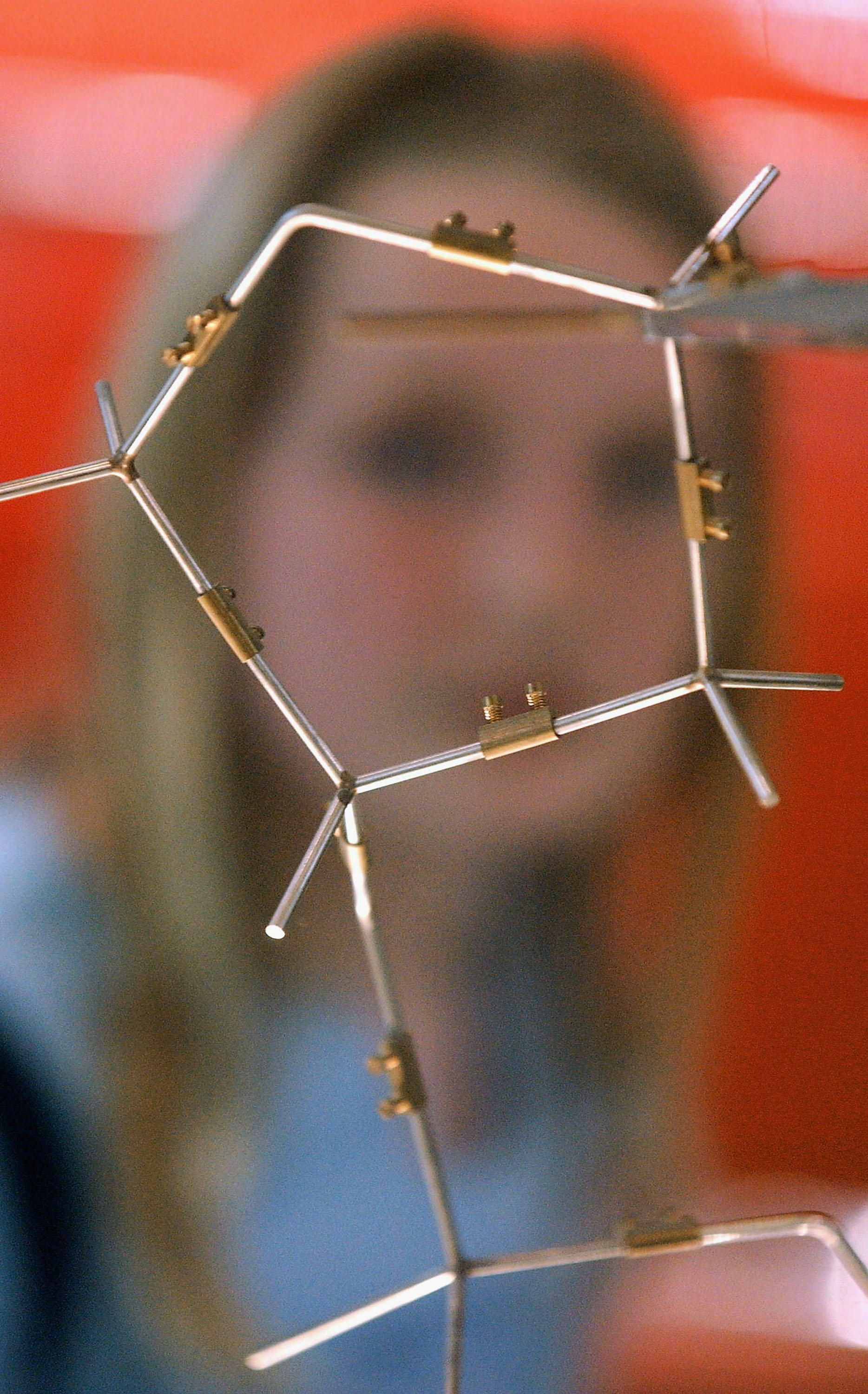 A blurry image of a woman in front of a representation of molecules