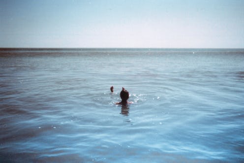 Recovering addicts swimming in the middle of the sea on a bright summer day